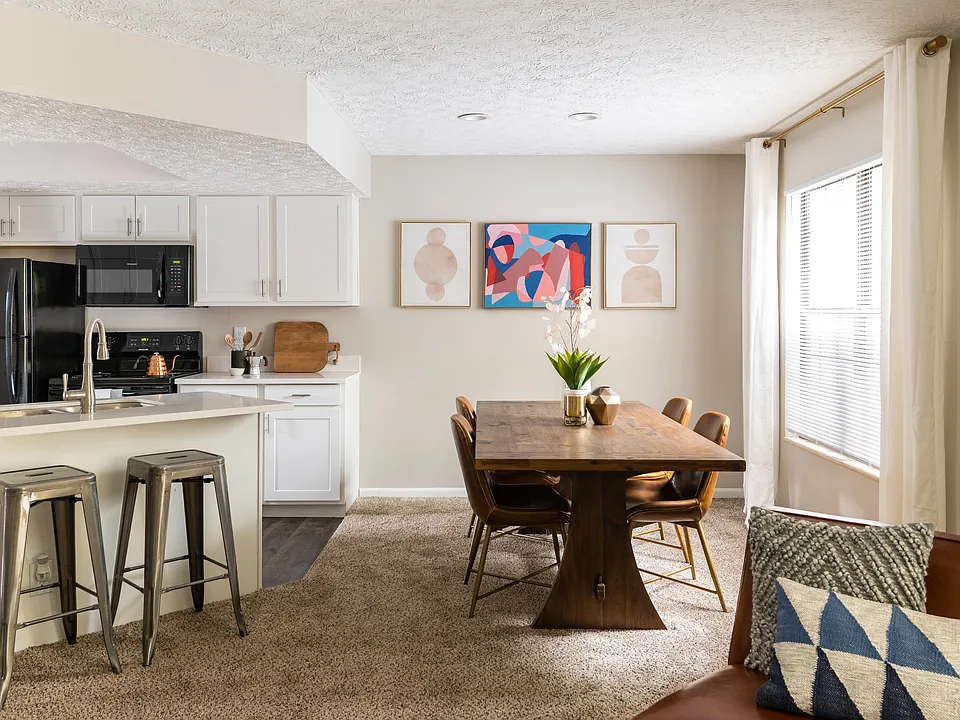 Dining Area with Plush Carpet and Kitchen with Granite Countertops