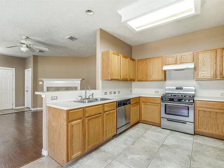 Stainless sink and appliances in spacious kitchen