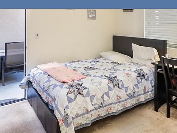 Downstairs bedroom. Outside is the side yard.