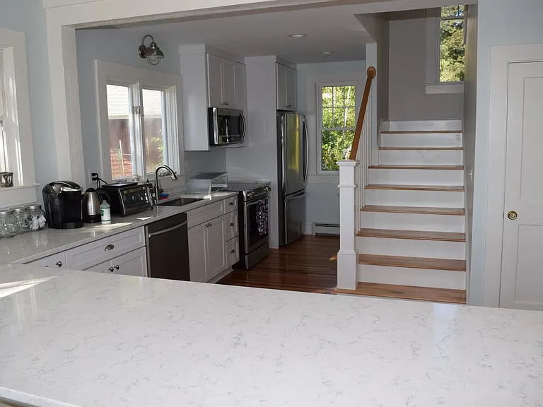 Kitchen with stainless steel appliances and quartz counterto