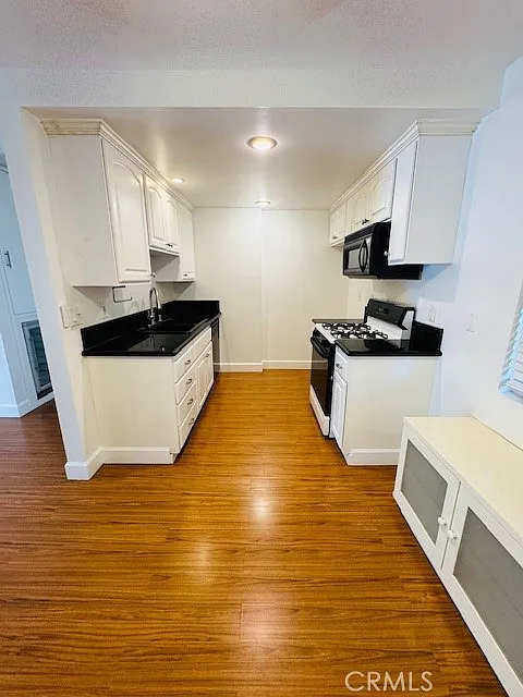 Building Photo - 6600 Warner Ave #209