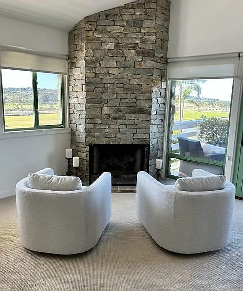 Master bedroom cozy seating with 2 swivel chairs and FP