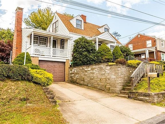 The garage and the porch above it are just two of the great features of this lovely home.