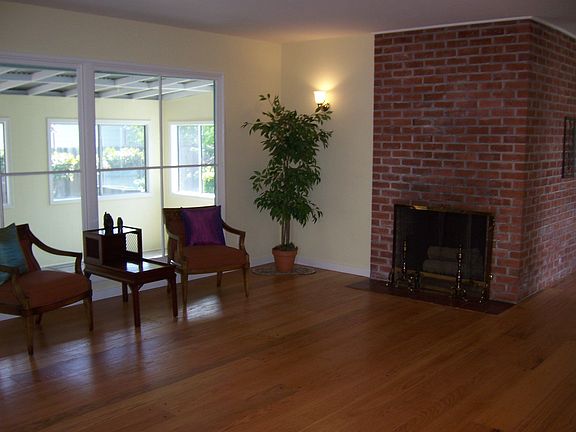 Large Living Room W/ Glemaing Hardwood Floors and Woodburning Fireplace