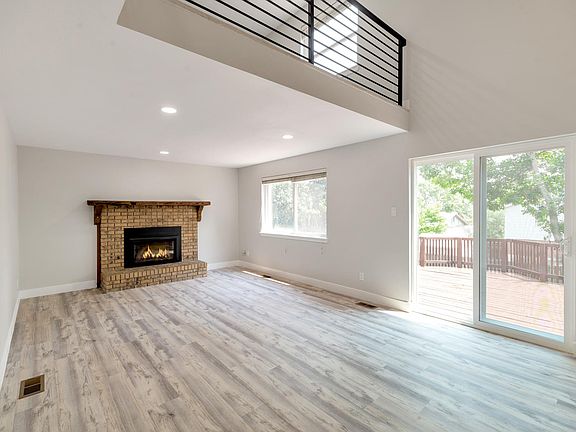 Living room with gas fireplace and backyard access