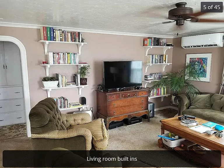 Solid oak built-ins, Ductless Heat and A/C on the wall. Hall storage visible at left.