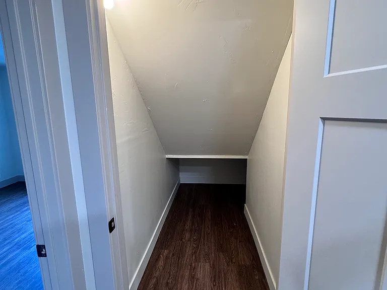 Practical under-stair storage area offering valuable extra storage.