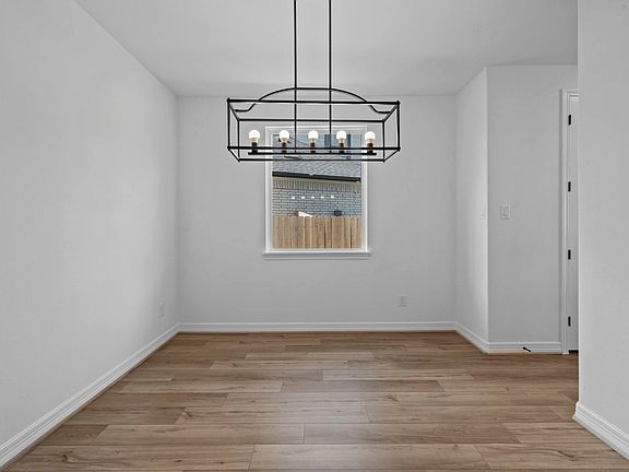 Sophisticated dining space with a contemporary chandelier, perfect for entertaining.