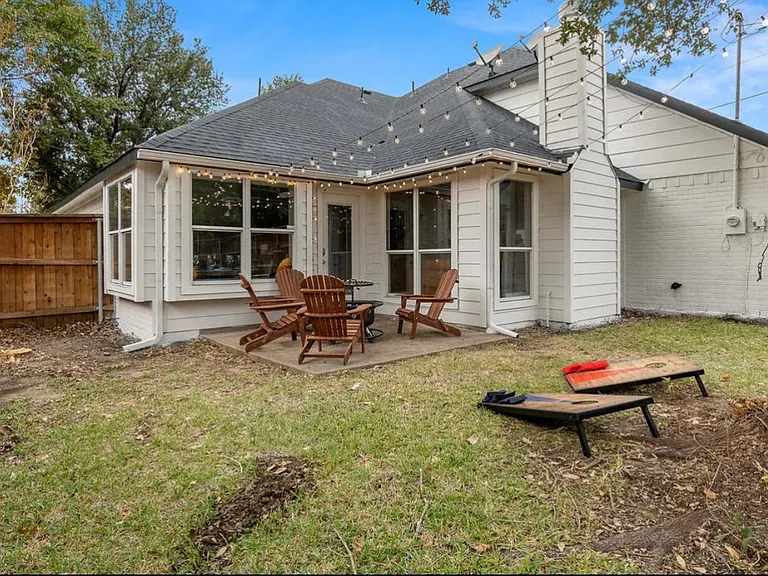Backyard has plenty of seating and firepit/grill.