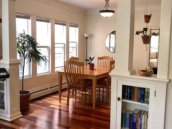 Dining room with abundant natural light and hardwood floors.
