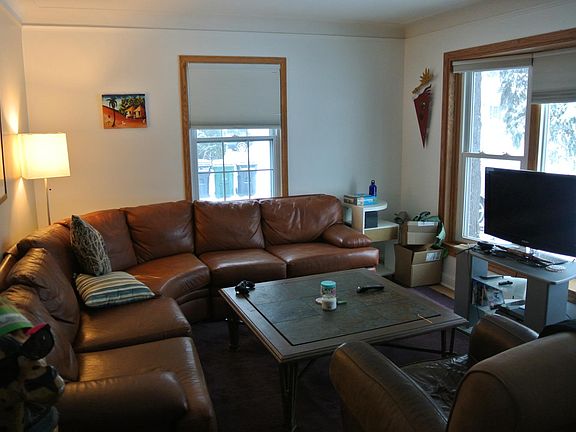 living room facing south towards the garage. The street is out the main window on the right.