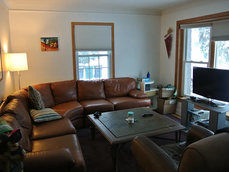 living room facing south towards the garage. The street is out the main window on the right.