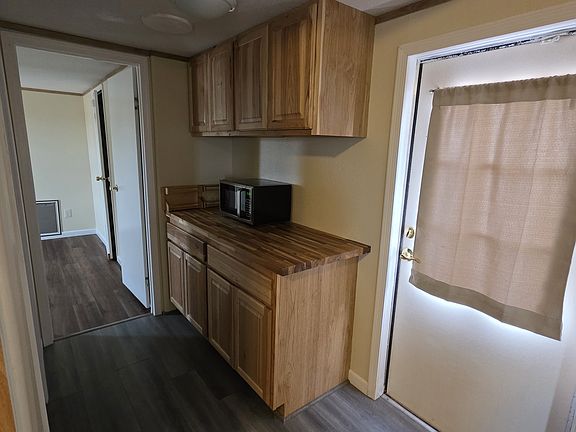 More cabinets with a microwave and spice rack