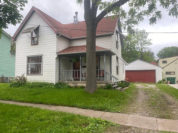 Two car garage, large work bench, walk of attic with storage space and automatic garage door opener.