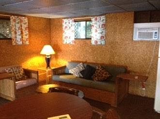 LIVING ROOM IS 500 SF. HAS 2 COUCHES , 4 EASY CHAIRS AND A RECLINER, TABLE WITH 4 CHAIRS, KITCHENETTE W/ FRIDGE, RANGE & MICROWAVE, BAR WITH 3 STOOLS, AND A 65" FLAT TV. ROOM IS BIG ENOUGH FOR A BIG CROWD TO WATCH SPORTS OR RACES WHILE ENJOYING A TWO M