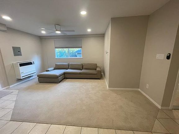 Living room. Brand new carpet. Couch available for purchase if desired; otherwise will be removed.