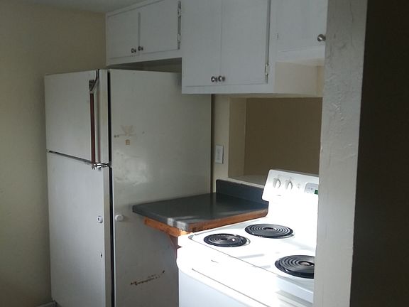 Cabinets over the stove and a pass thru to the dining area.