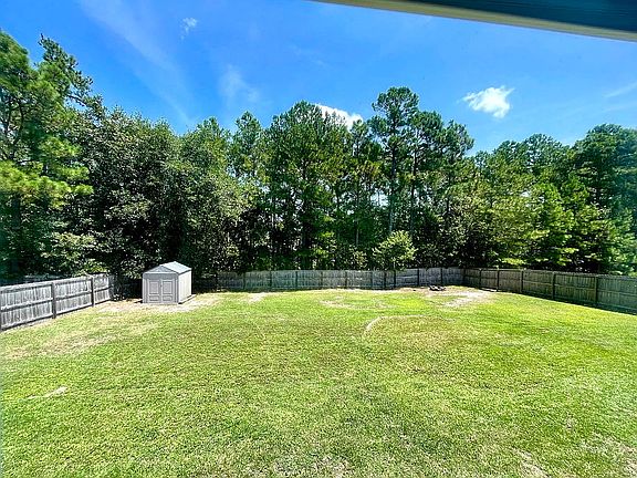 Fenced yard w/ storage shed