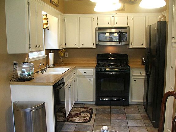Cozy kitchen with black appliances. Freshly painted cabinets with new hardware.