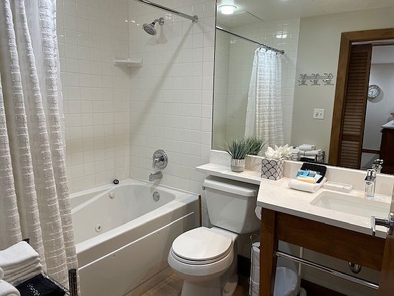 New quartz countertop, LVP flooring, sink, and faucet.