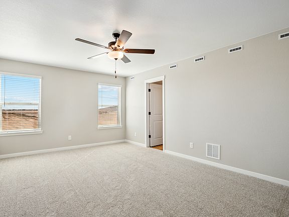 The master bedroom is spacious with large windows.