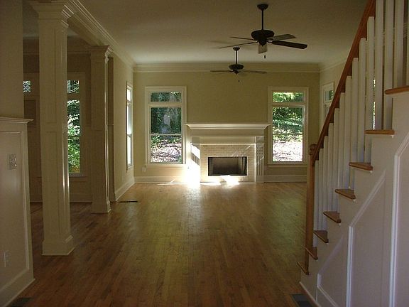 Large Living Space with Hardwood Flooring and Staircase Accessible
