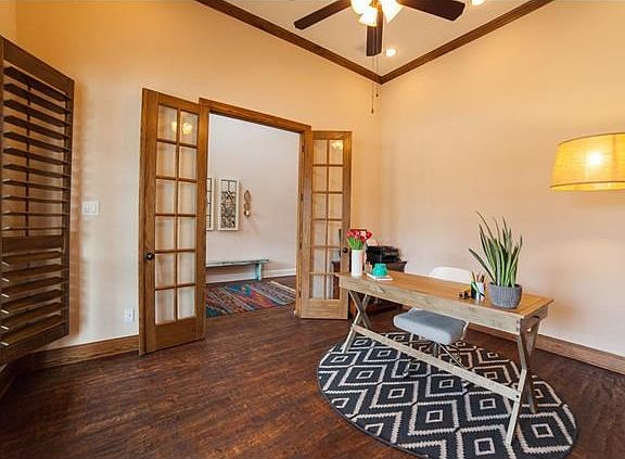 Dedicated study with custom plantation shutters and unique, deeply scrapped hardwood floors!