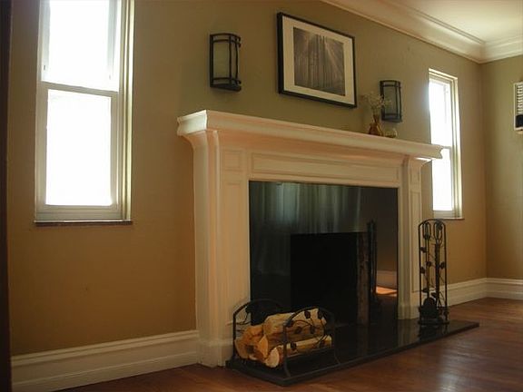 black granite surrounds natural fireplace in living room