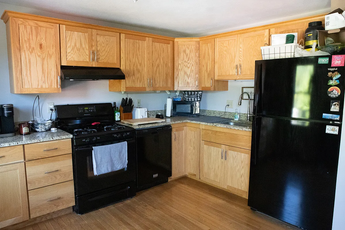 Kitchen includes fridge, oven, dishwasher, fan and a countertop microwave - 8 Leith Ct