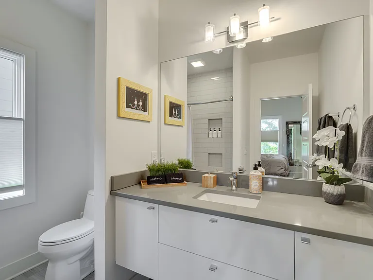 Private ensuite bathroom featuring a shower/tub combination, Italian soft-close cabinetry, and stocked with plush towels, hand soap, shampoo, conditioner, and body wash for your convenience.