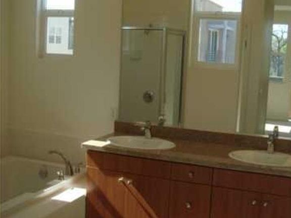 Double vanity, large bath tub, and separate shower in master bathroom on top floor.