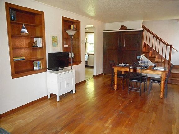 Living and Dining Room Combination: Living Room: With the right offer, this wonderful storage cabinet in the back of the room wi