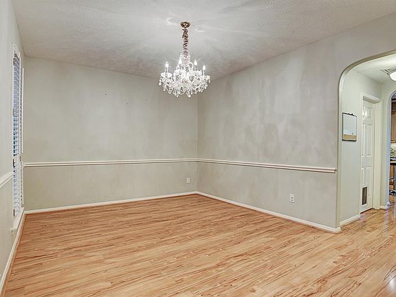 Formal dining has great views of the front of yard through the shutters covered windows.