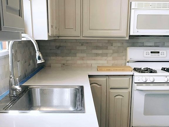 Kitchen featuring quartz countertops and a marble backsplash!