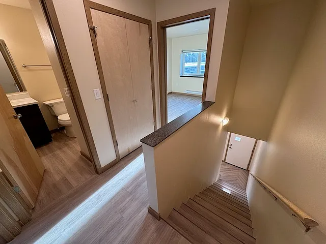 Top of stairs, looking down and towards Master Bedroom and bathroom