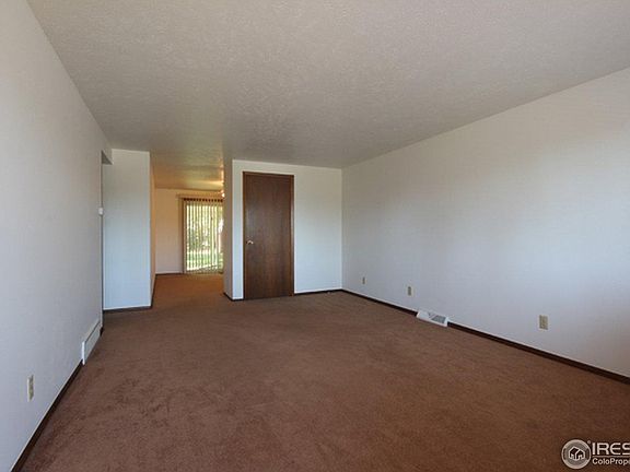 The dining room and kitchen are at the rear of the home to the right. The bedrooms and bathroom are off to the left.