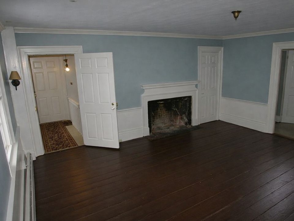 Living Room showing entry door open from the stairway. Note that the fireplace is NOT operational.