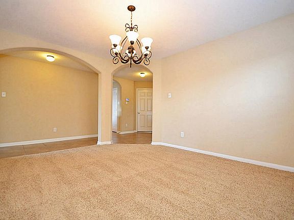 Lovely formal dining room detailed out with entry arches and oil rubbed bronze chandelier!