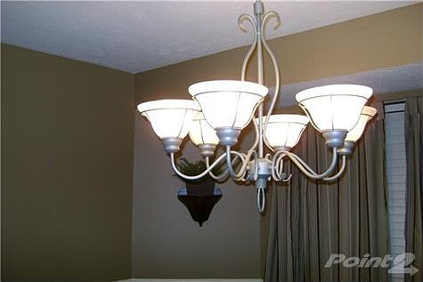 Dining room with updated light fixture, chair rail and designer paint colors.
