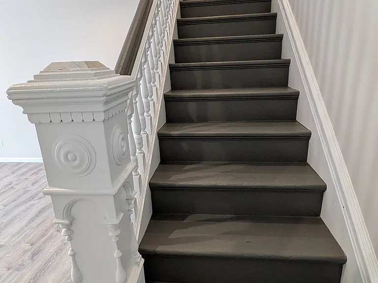 solid wood staircase leads upstairs to 3 bedrooms and a bathroom