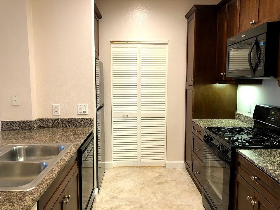 Kitchen with closet door to washer and dryer