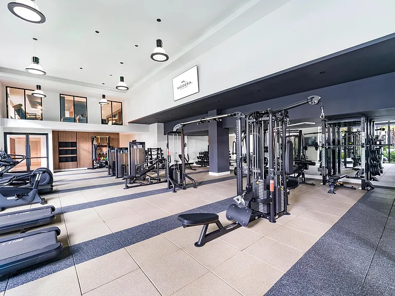 A light-filled fitness center at Modera Aventura, thoughtfully designed with modern equipment.