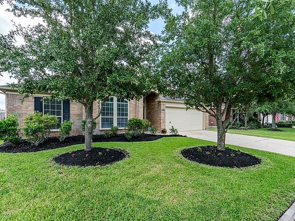Mature trees and lush landscaping provides great curb appeal for this charming home!