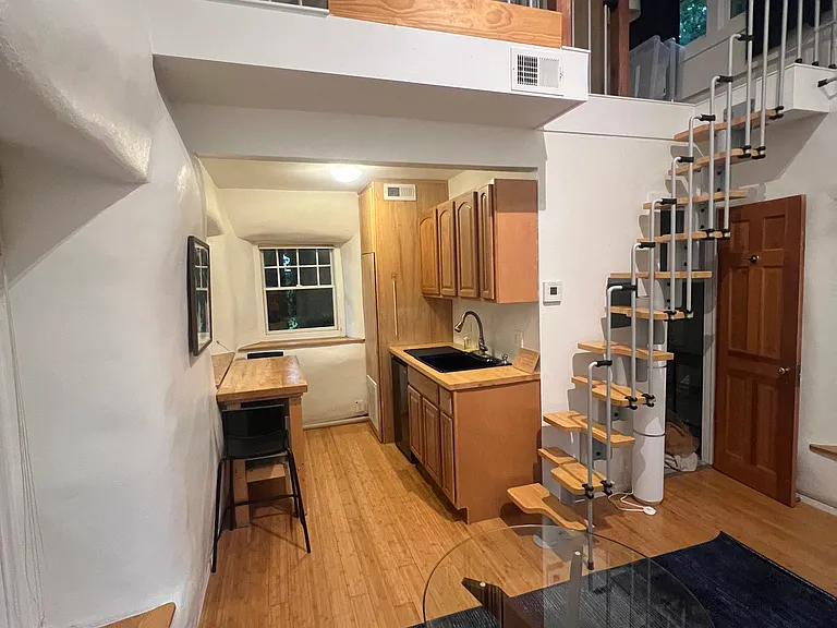 Functional kitchenette with generous counter and cabinet space, large sink, microwave, convection oven, electric cooktop and dining seating.
