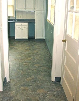 View of hallway entrance and kitchen from the living room.