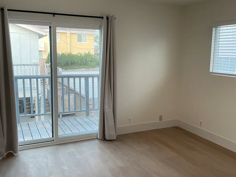bedroom-3 Bedrooms with new windows, custom blinds, modern sliding closets featuring glossy white and mirrored glass doors, and direct access to a private balcony