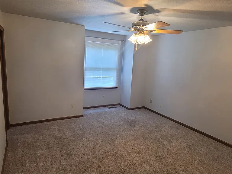 The first bedroom is a L x W space and offers pre-installed blinds and curtain rods to suit your style.