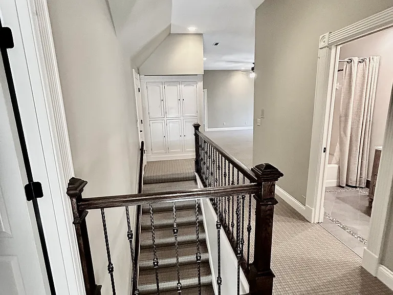 Stairwell to recreation/media room and 3 bedrooms with 3 full bathrooms