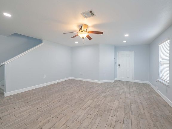 Recessed lights and Ceiling fan in living room.