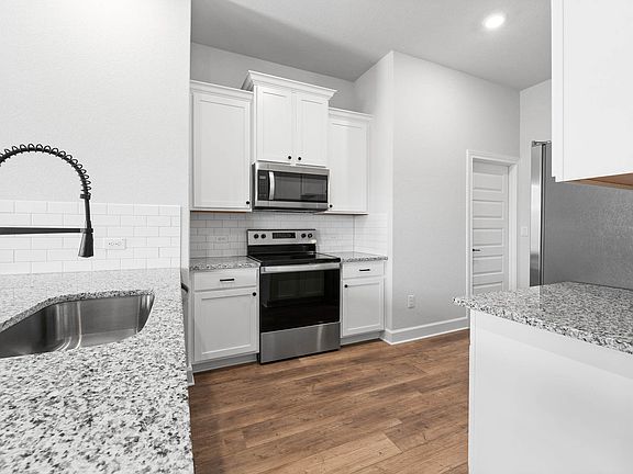 The kitchen has sprawling granite countertops.
